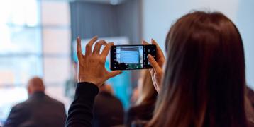 Woman taking photo during presentation